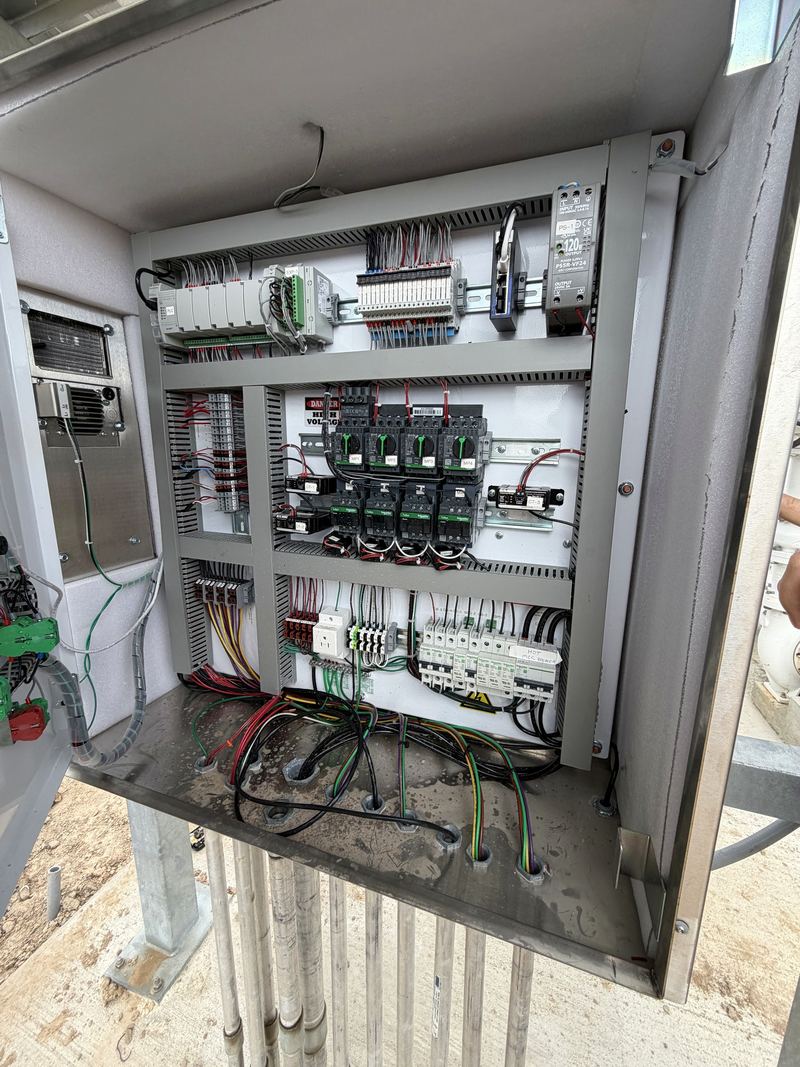 Open PLC control panel with DIN rail components and wire duct