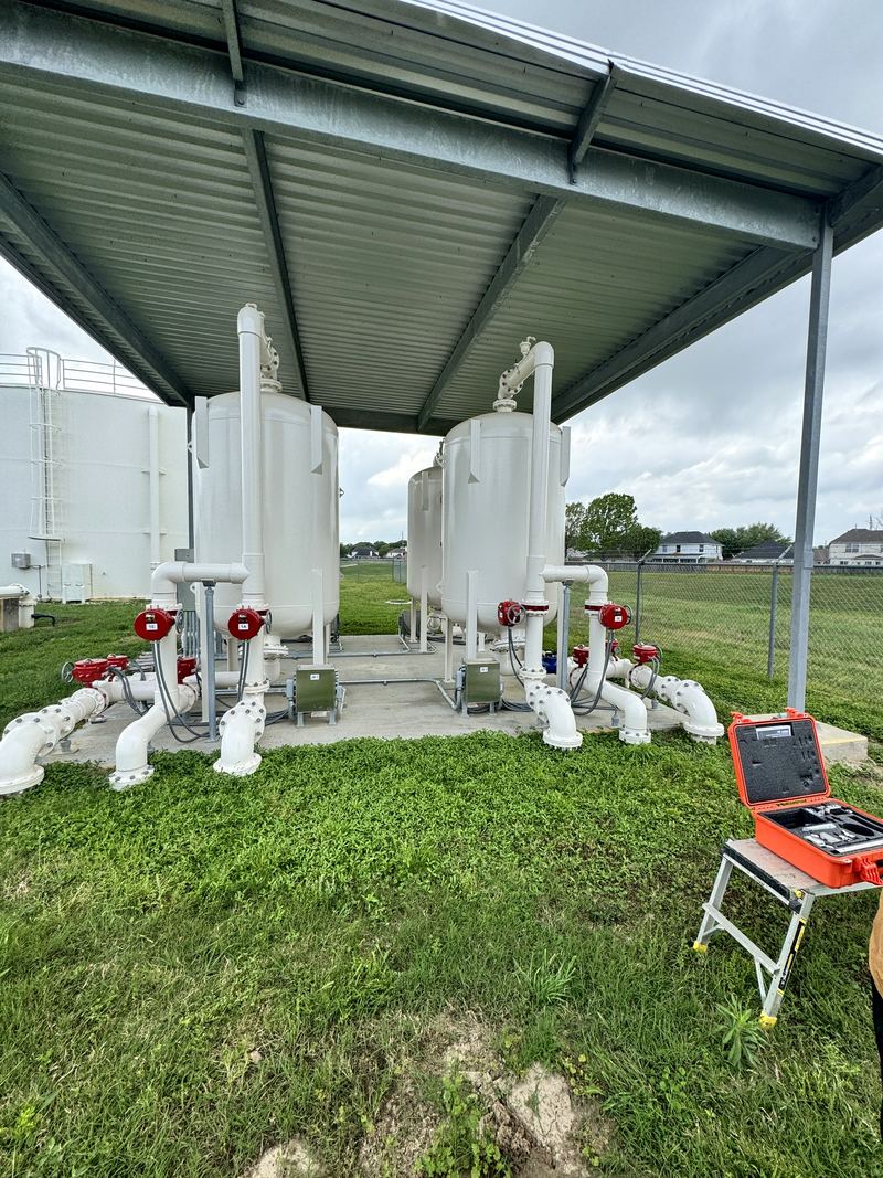 Water treatment filters at a customer site during commissioning, with test equipment on site