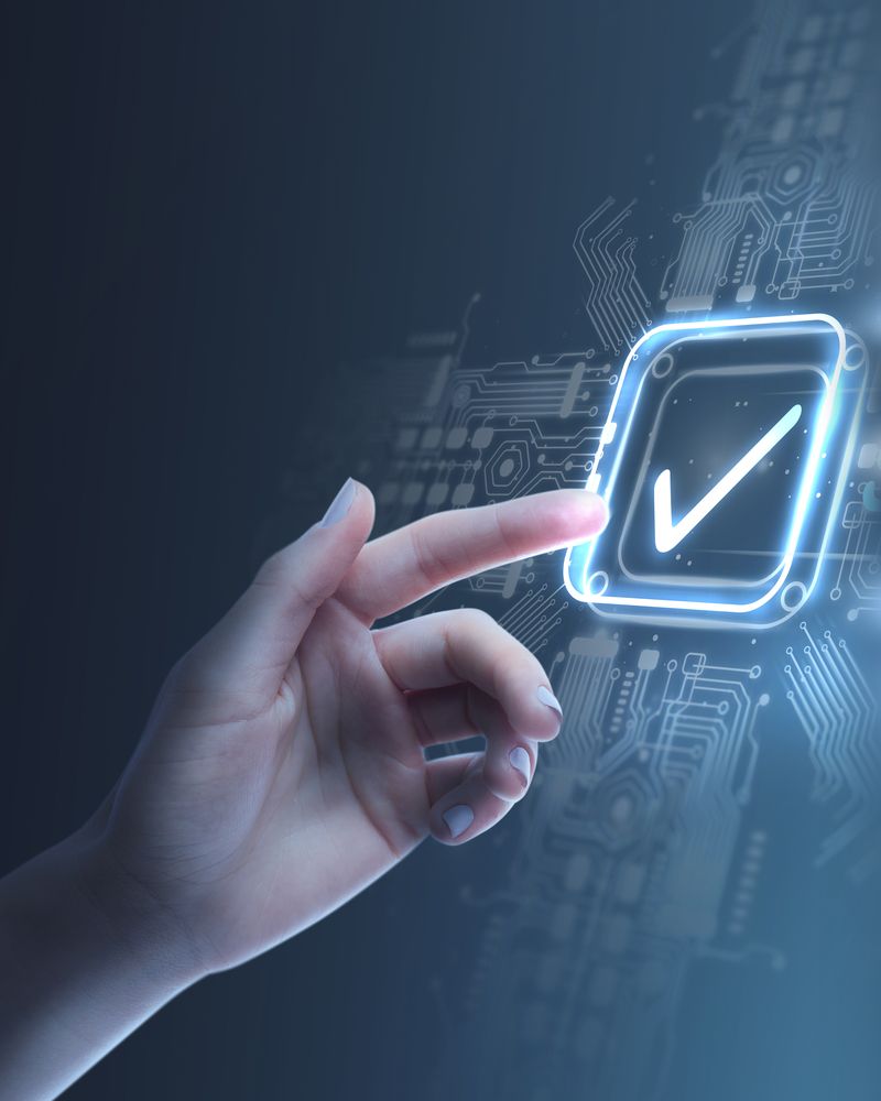 Hand selecting a glowing checkmark representing quality standards